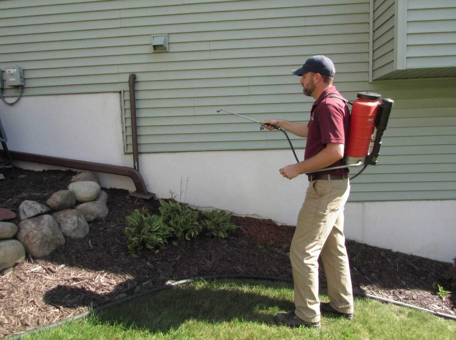 A residual spray along the foundation and wall of a house